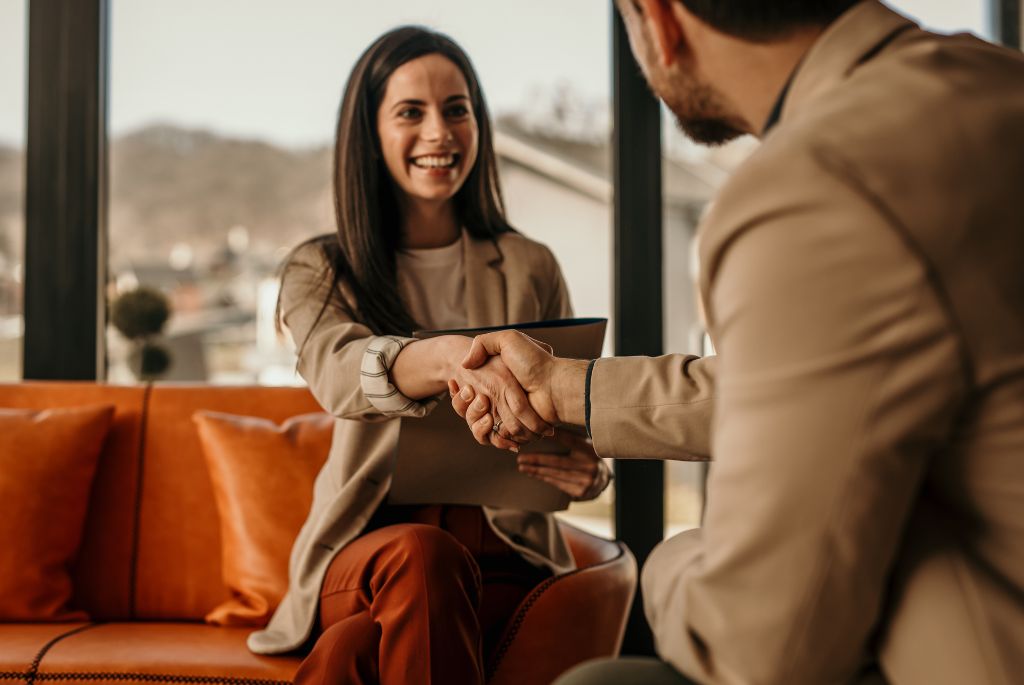 woman shaking mans hand during contract to hire transition